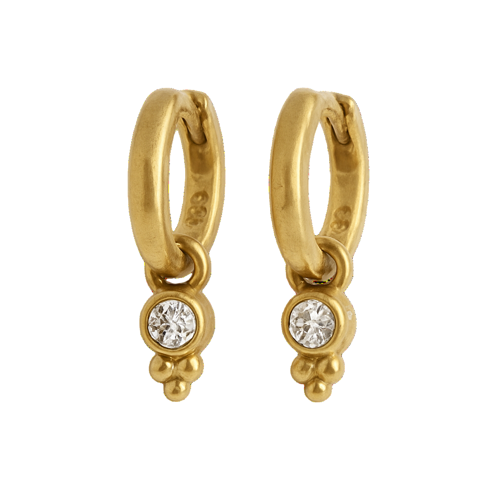 Gold hoop earrings with small round gemstones on a white background