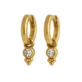 Gold hoop earrings with small round gemstones on a white background